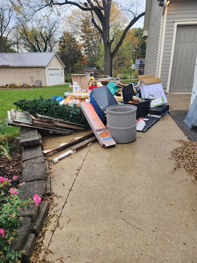 Dumpster being loaded with debris for Estate Cleanout Dumpster Rental in Nichols Hills